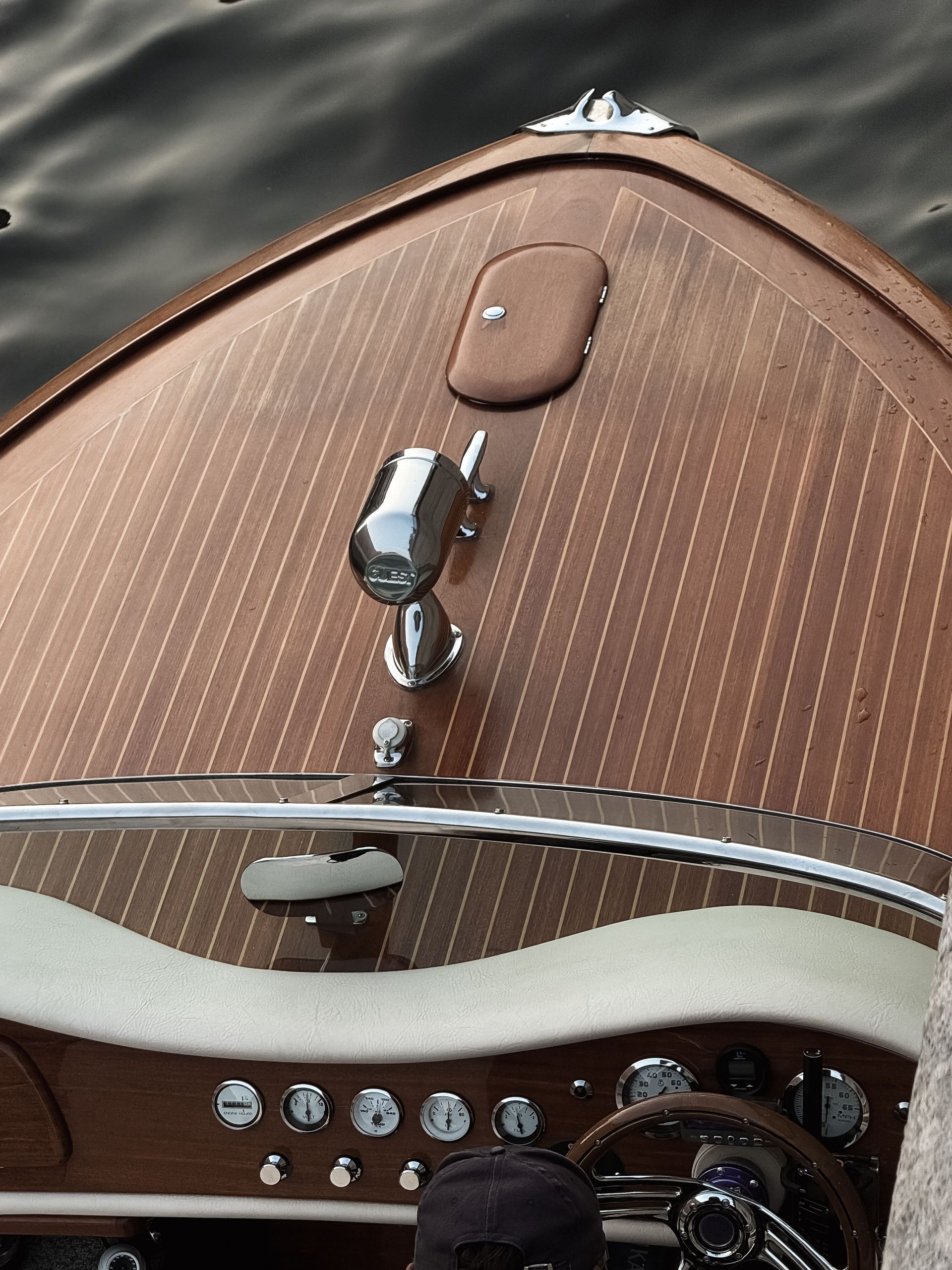 Top view of a classic wooden speedboat showing its elegant deck and controls.